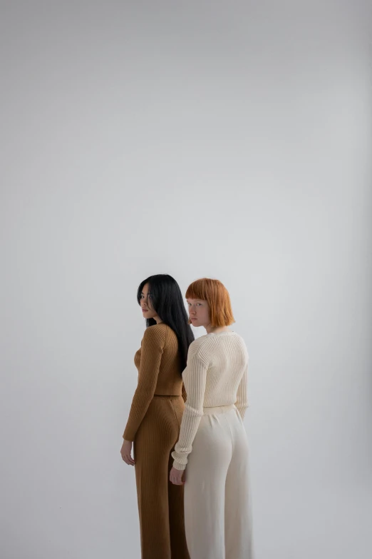 a couple of women standing next to each other, inspired by Vanessa Beecroft, trending on pexels, minimalism, ivory and copper, hr ginger, asian human, white sleeves