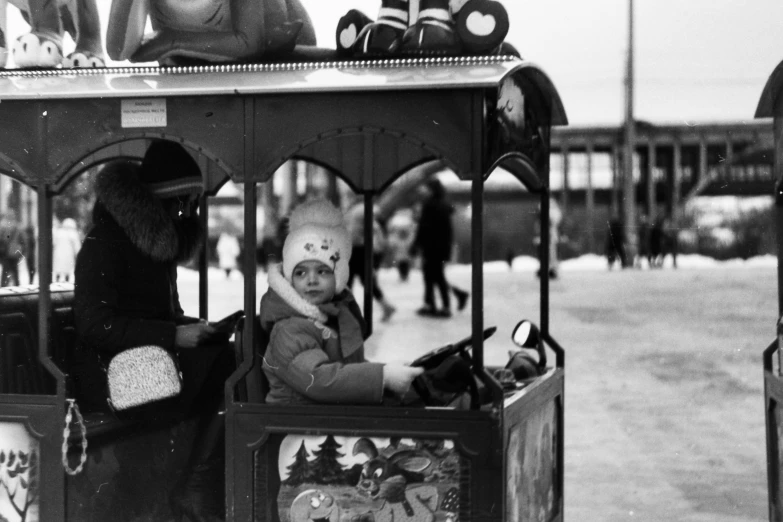 a black and white photo of a child in a toy train, a black and white photo, winter photograph, curiosities carnival, young tsar, square