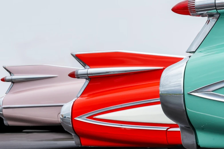 a row of classic cars parked next to each other, an airbrush painting, by Doug Ohlson, trending on unsplash, retrofuturism, tail fin, silver red white details, green bright red, closeup - view