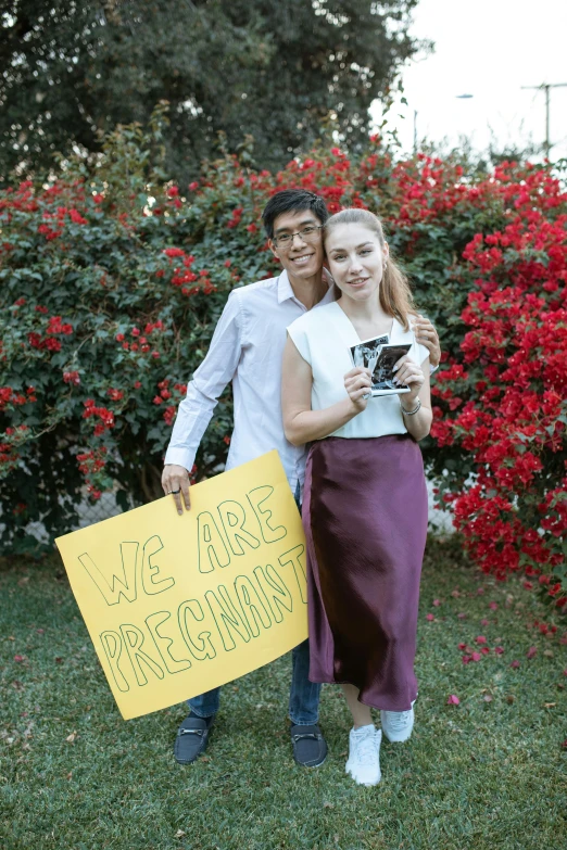 a man standing next to a woman holding a sign, reddit, profile image, square, pregnancy, high school