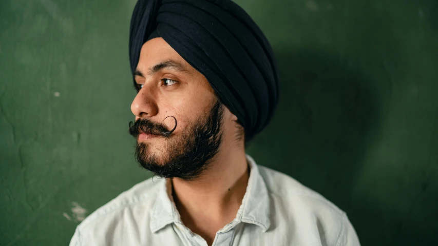 a close up of a person wearing a turban, a character portrait, trending on pexels, thin moustache, post graduate, stubble, engineer