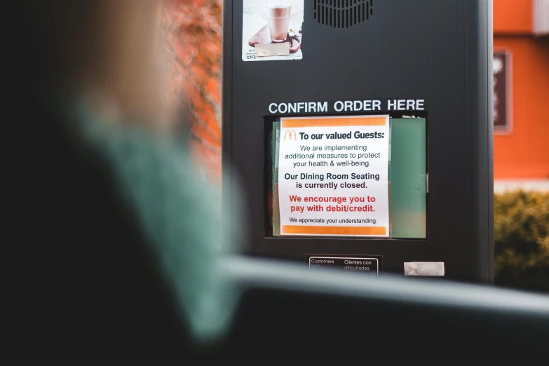 a person standing in front of a vending machine, a poster, unsplash, private press, faked ticket close up, some people are sitting, patreon content, warning