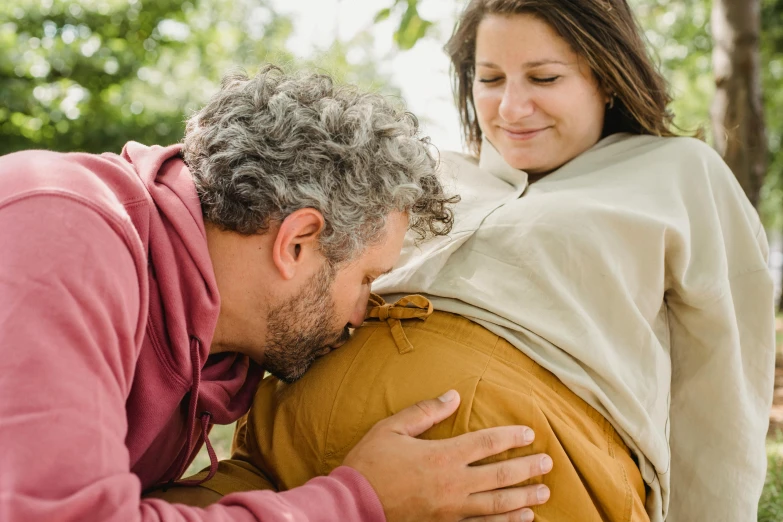 a man sitting next to a woman on a bench, trending on pexels, renaissance, membrane pregnancy sac, organic detail, brown, nursing