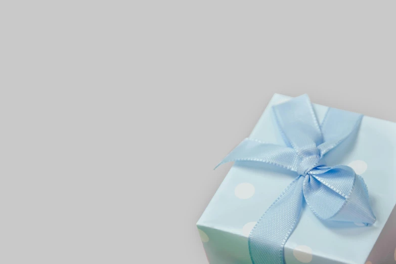 a small blue gift box with a blue bow, by Emma Andijewska, pexels contest winner, light grey background, background image, polka dot, square