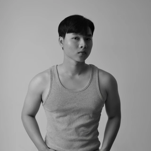 a black and white photo of a man in a tank top, inspired by Joong Keun Lee, studio medium format photograph, kim doyoung, stanley artger m lau, young adult male