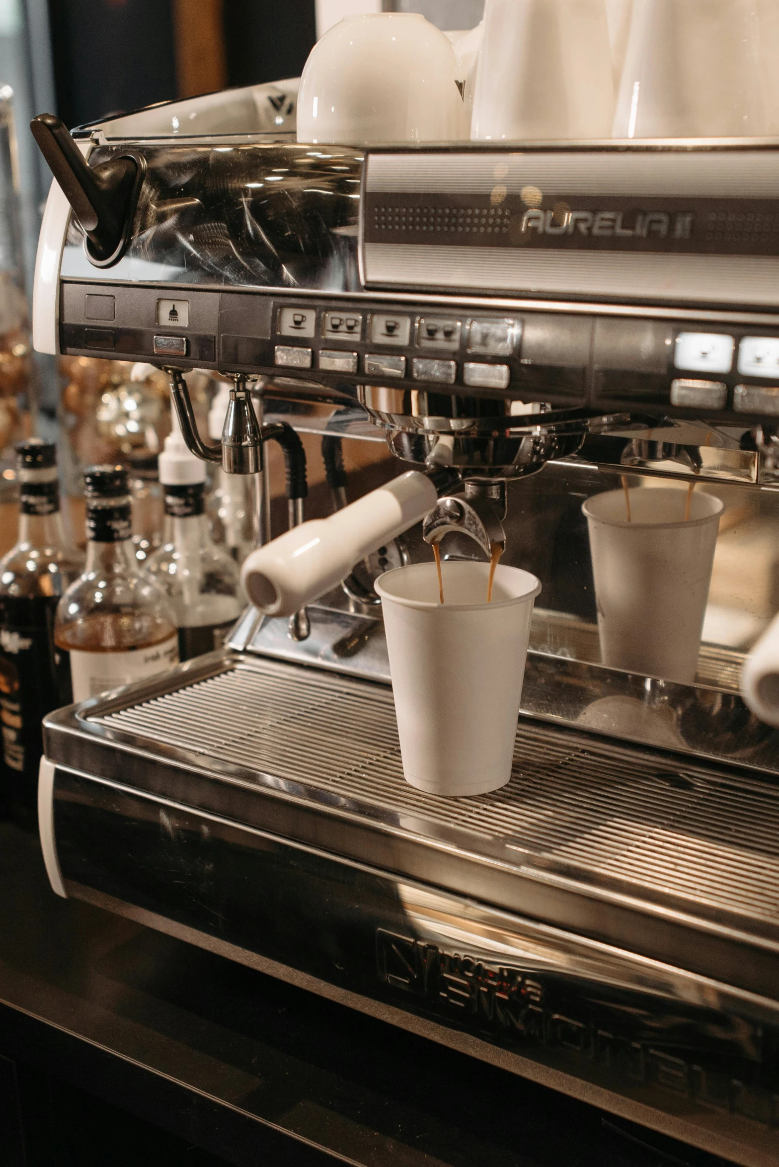 a coffee machine sitting on top of a counter, by Bernard D’Andrea, trending on pexels, purism, cups and balls, cafe lighting, thumbnail, high quality photo