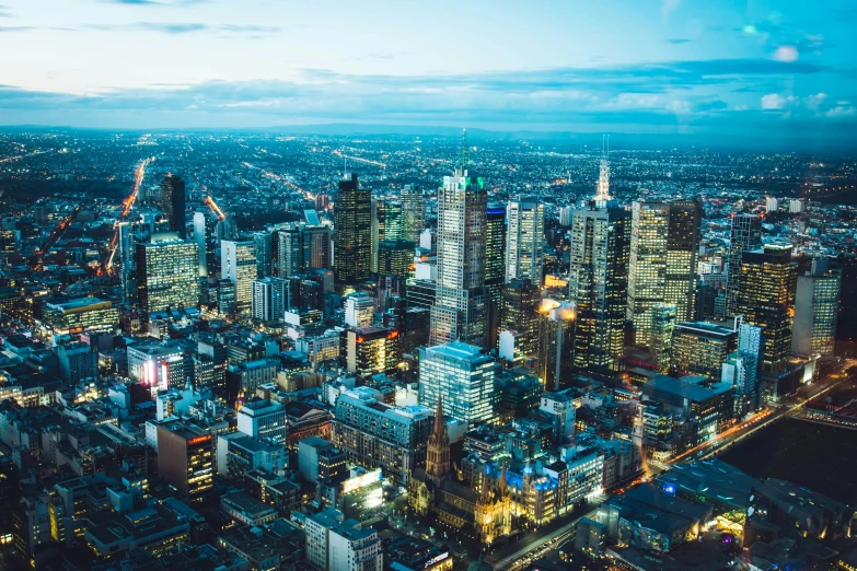 an aerial view of a city at night, by Liza Donnelly, pexels contest winner, melbourne, daylight, towering, instagram post