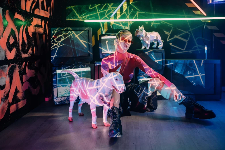 a man sitting on top of a wooden floor next to a dog, a hologram, by Julia Pishtar, lasers and neon circuits, beth cavener, husky in shiny armor, animatronic