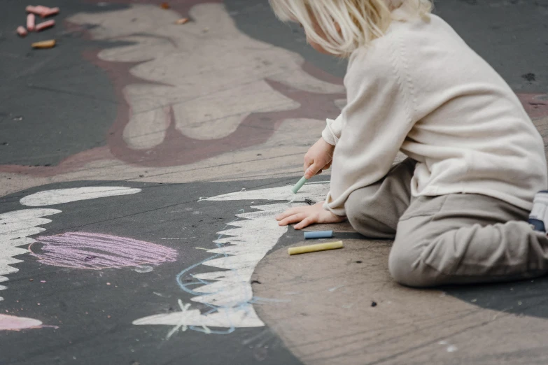 a little girl sitting on the ground drawing with chalk, by Helen Stevenson, pexels contest winner, interactive art, eva elfie, animals in the streets, grey, on canvas