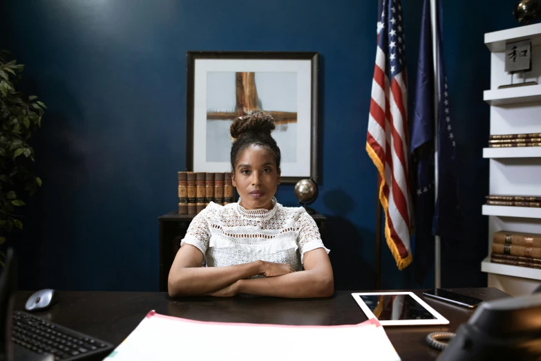 a woman sitting at a desk in an office, a portrait, by William Berra, unsplash, halle berry, holding court, 15081959 21121991 01012000 4k, aida muluneh