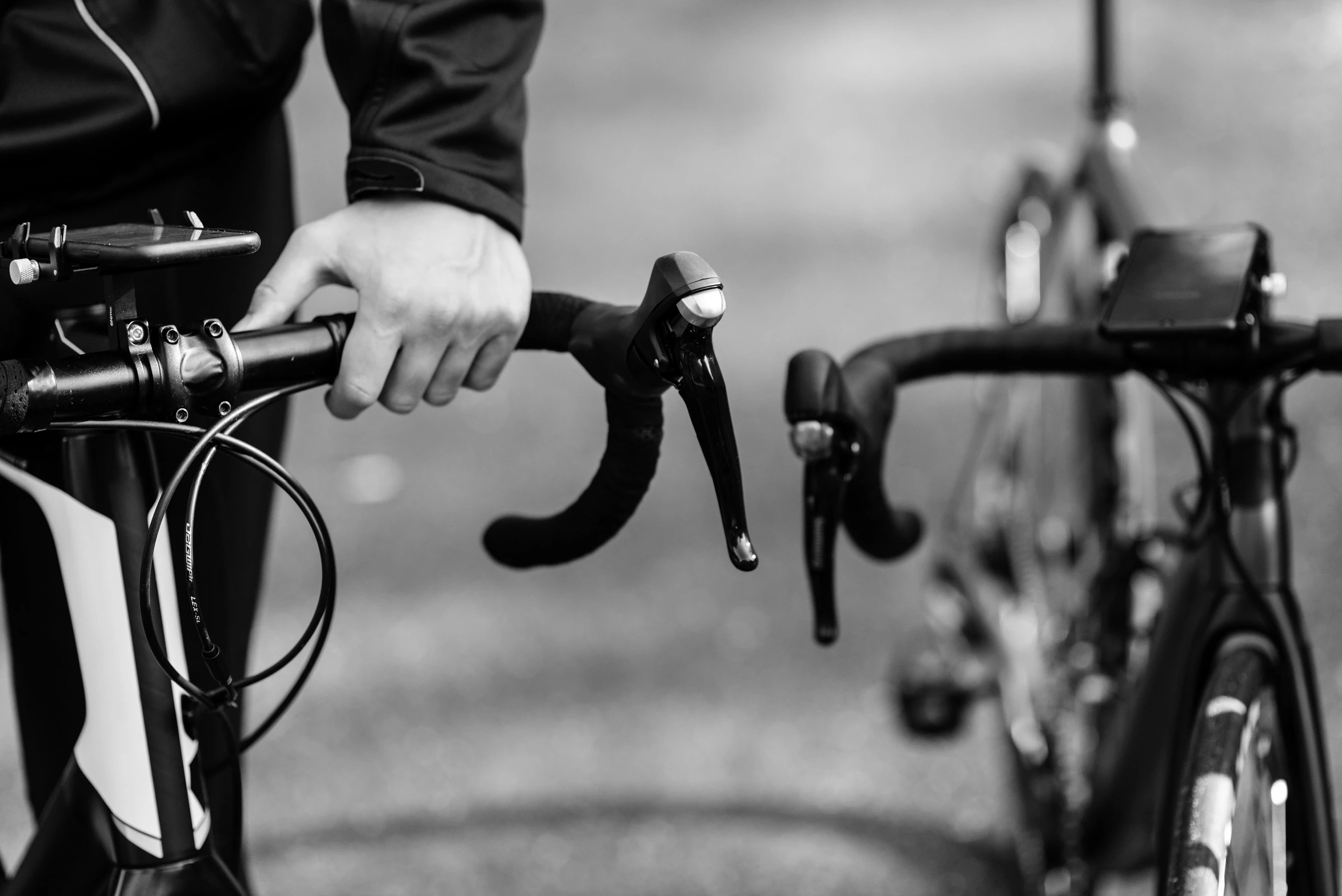 a black and white photo of a person on a bike, levers, gripping, uploaded, item