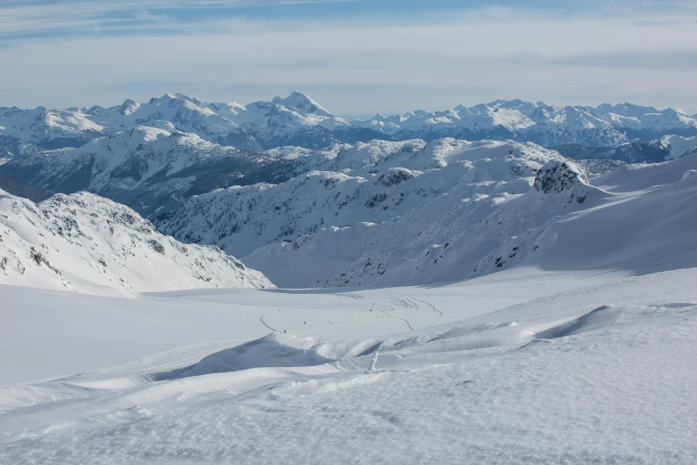 a person riding skis on top of a snow covered slope, by Werner Andermatt, pexels contest winner, valley in the distance, avatar image, aerial photo