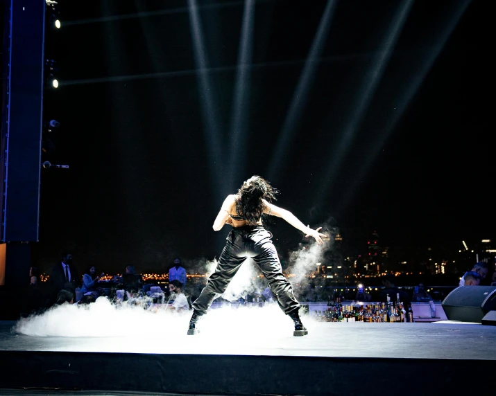 a woman that is standing on a stage, bullet time, in an arena, taken with sony alpha 9, dazzling lights