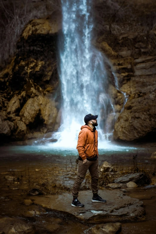 a man standing in front of a waterfall, pexels contest winner, rugged face, slovakia, casually dressed, award winning color photo