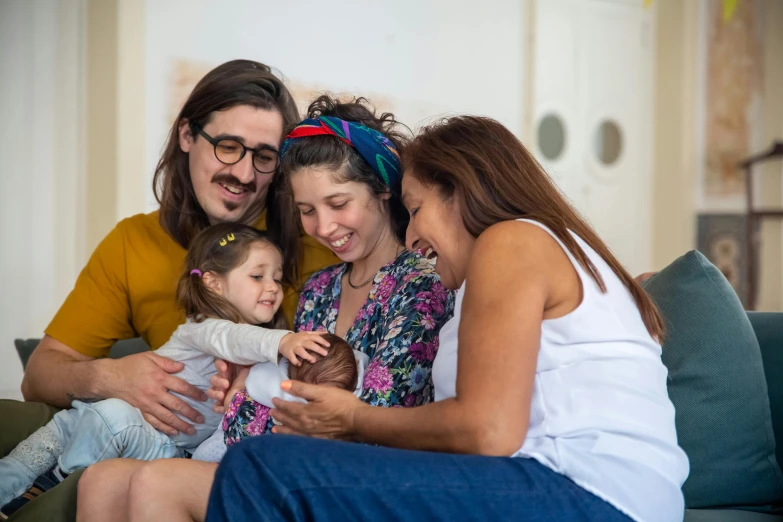 a family sitting on a couch looking at a cell phone, pexels contest winner, alena aenami and lilia alvarado, the birth, australian, avatar image