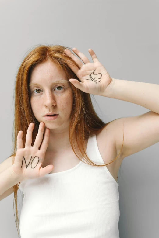 a woman with a pair of scissors on her hands, by Harriet Zeitlin, shutterstock, a redheaded young woman, woman holding sign, no skin shown, raised hand