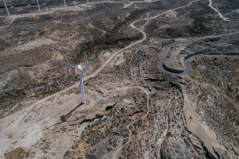 an aerial view of a wind farm in the desert, by Alejandro Obregón, pexels contest winner, les nabis, cyprus, landfill, grey, thumbnail