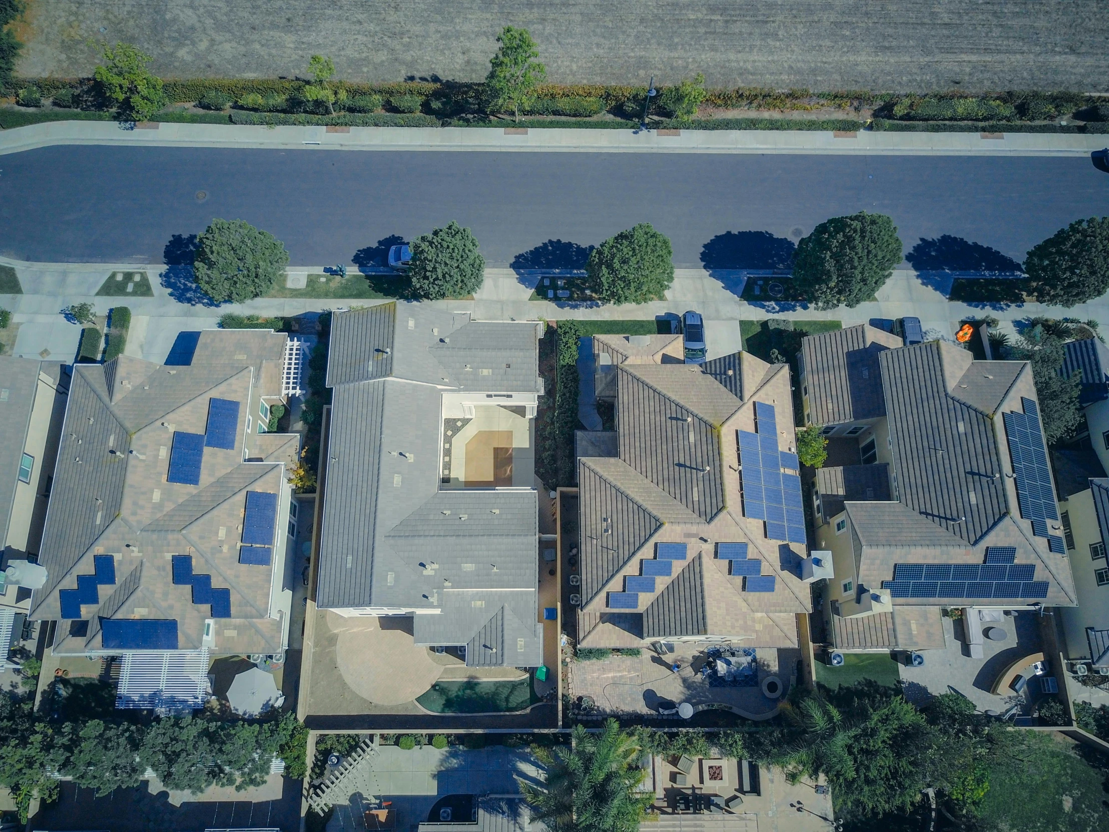 an aerial view of a house with solar panels on the roof, by Ryan Pancoast, renaissance, oceanside, background image, andrew thomas huang, bottom angle