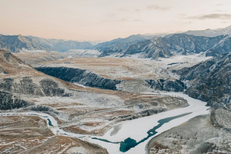 a river running through a snow covered valley, by Peter Churcher, unsplash contest winner, hurufiyya, erosion channels river, zac retz, center of picture, ash thorp khyzyl saleem