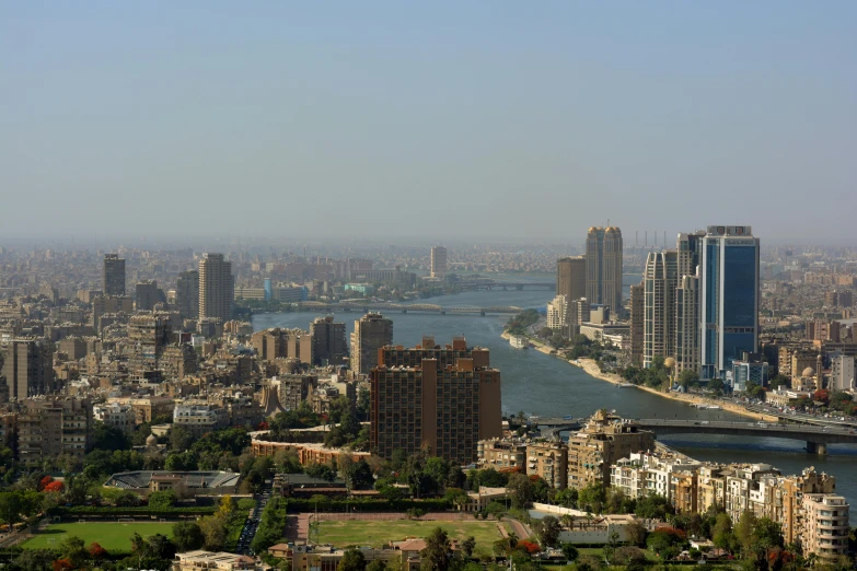 a large body of water surrounded by tall buildings, by Bouchta El Hayani, nile river environment, slide show, gigapixel photo