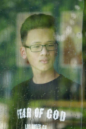 a young man standing in front of a window, a picture, inspired by Rudy Siswanto, rain drops on face, with glasses on, slightly pixelated, profile picture 1024px