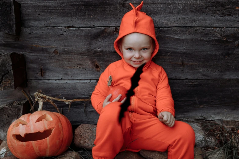a little boy sitting on a rock next to a pumpkin, inspired by Peter de Seve, pexels contest winner, antipodeans, wearing orange prison jumpsuit, joe biden dressed as a dinosaur, cracked, crawling out of a dark room