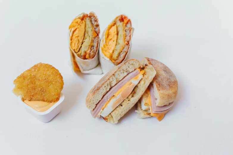 a sandwich cut in half with a side of potato chips, a picture, pexels, dau-al-set, crispy buns, various posed, 3 - piece, dusty and smokey