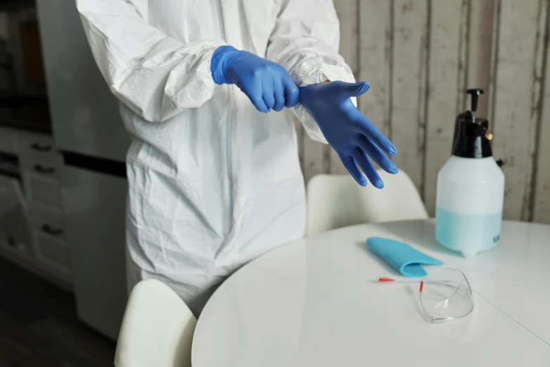 a person in a white lab coat and blue gloves, pexels contest winner, plasticien, tabletop, white sleeves, 5 feet away, angled