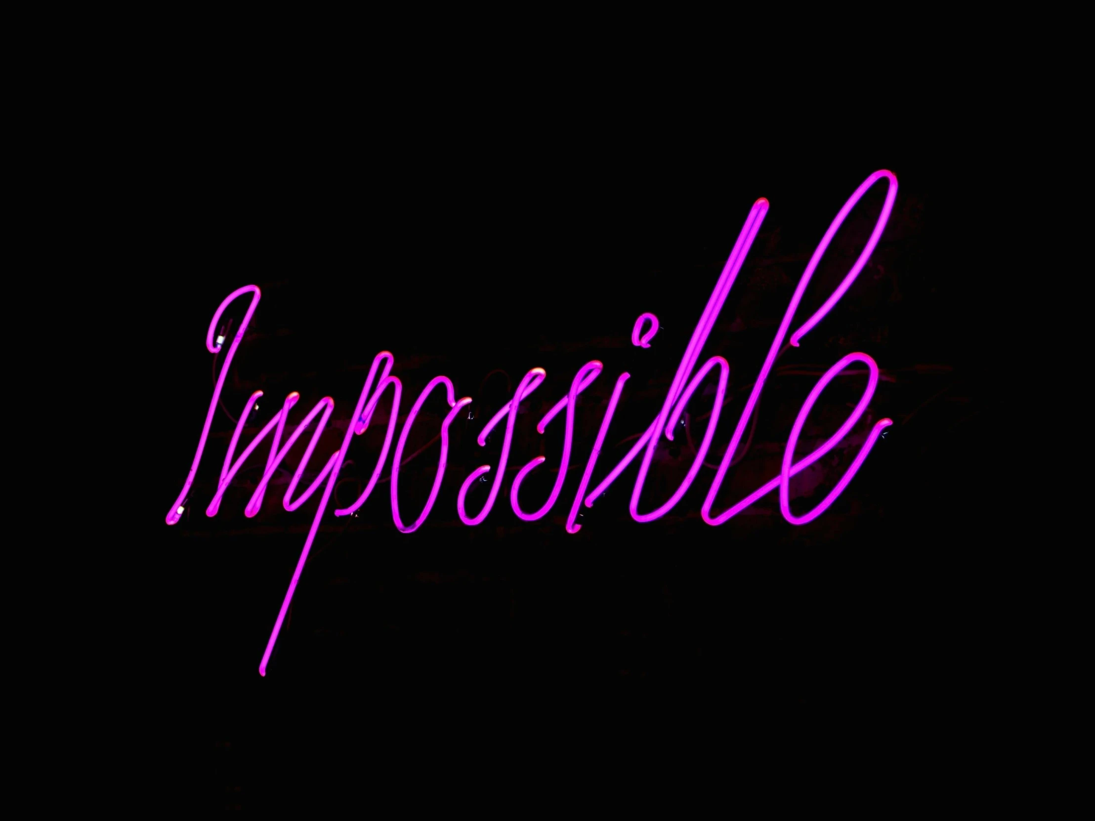 the word impossible on a black background, an album cover, inspired by David LaChapelle, soft neon purple lighting, 👰 🏇 ❌ 🍃, kim possible, pink neon lights