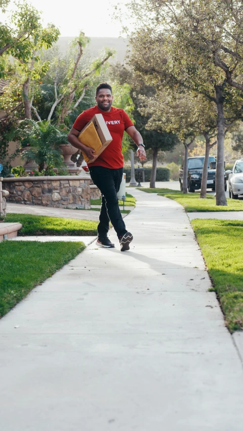 a man riding a skateboard down a sidewalk, delivering parsel box, kevin hart, at home, rex orange county