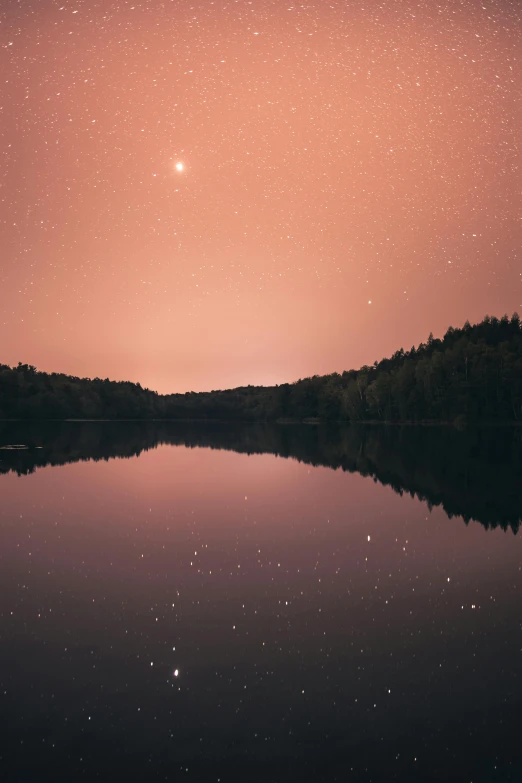 a large body of water under a purple sky, forest at night, the sky is a faint misty red hue, stars and planets visible, new hampshire