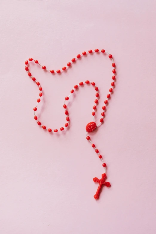 a rosary with a red cross on it, by Elsa Bleda, coral red, made out of plastic, high resolution print :1 red, pink