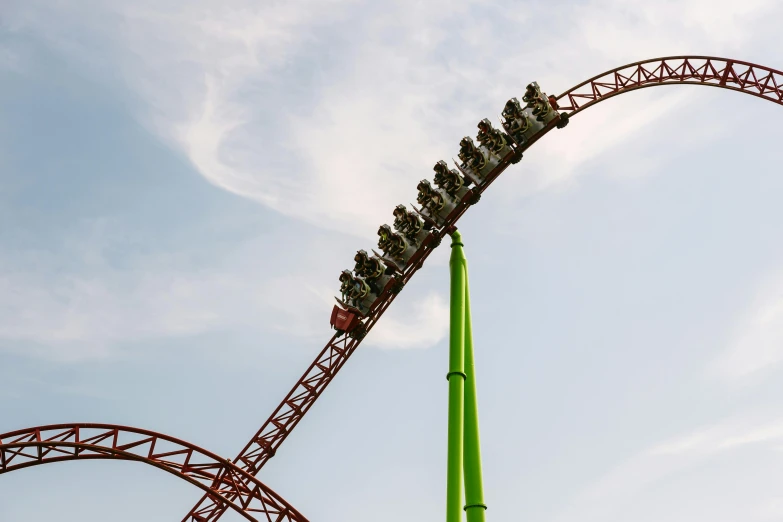 a group of people riding on top of a roller coaster, by Matthias Stom, pexels contest winner, hurufiyya, red green, profile image, thunderbird 2, slimer