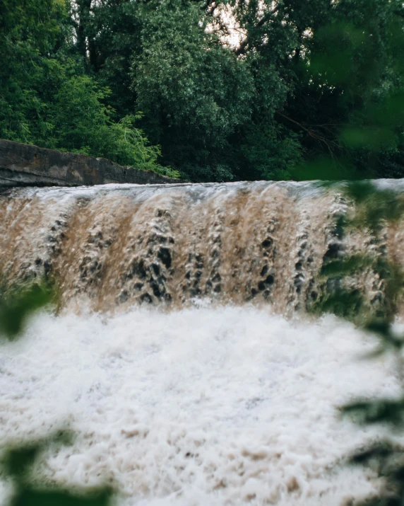 a man riding a wave on top of a river, an album cover, trending on unsplash, hurufiyya, small waterfalls, low quality photo, thumbnail, river in the wood