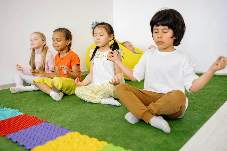 a group of children sitting on the floor doing yoga, trending on pexels, paradise garden massage, yellow carpeted, high rendering, thumbnail