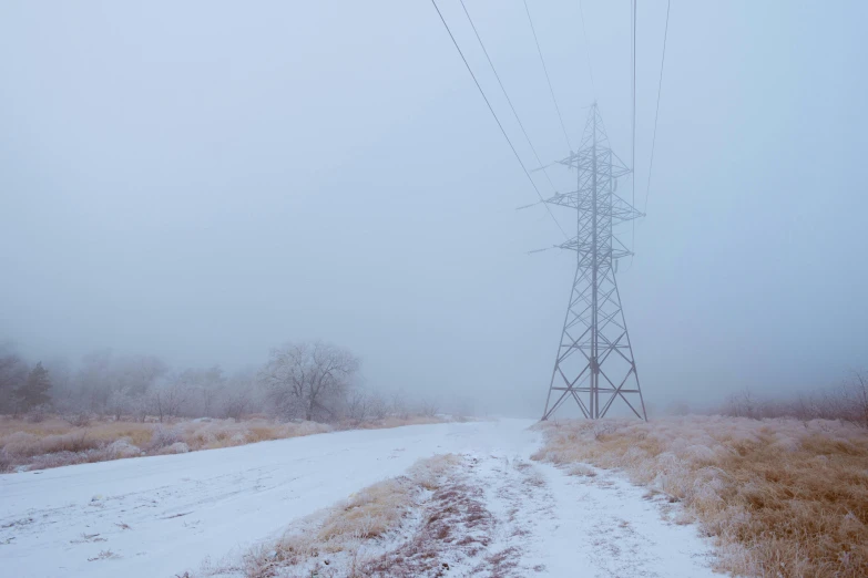 a snow covered field with power lines in the background, inspired by Elsa Bleda, unsplash contest winner, realism, dense volumetric fog, azamat khairov, archival pigment print, 2022 photograph