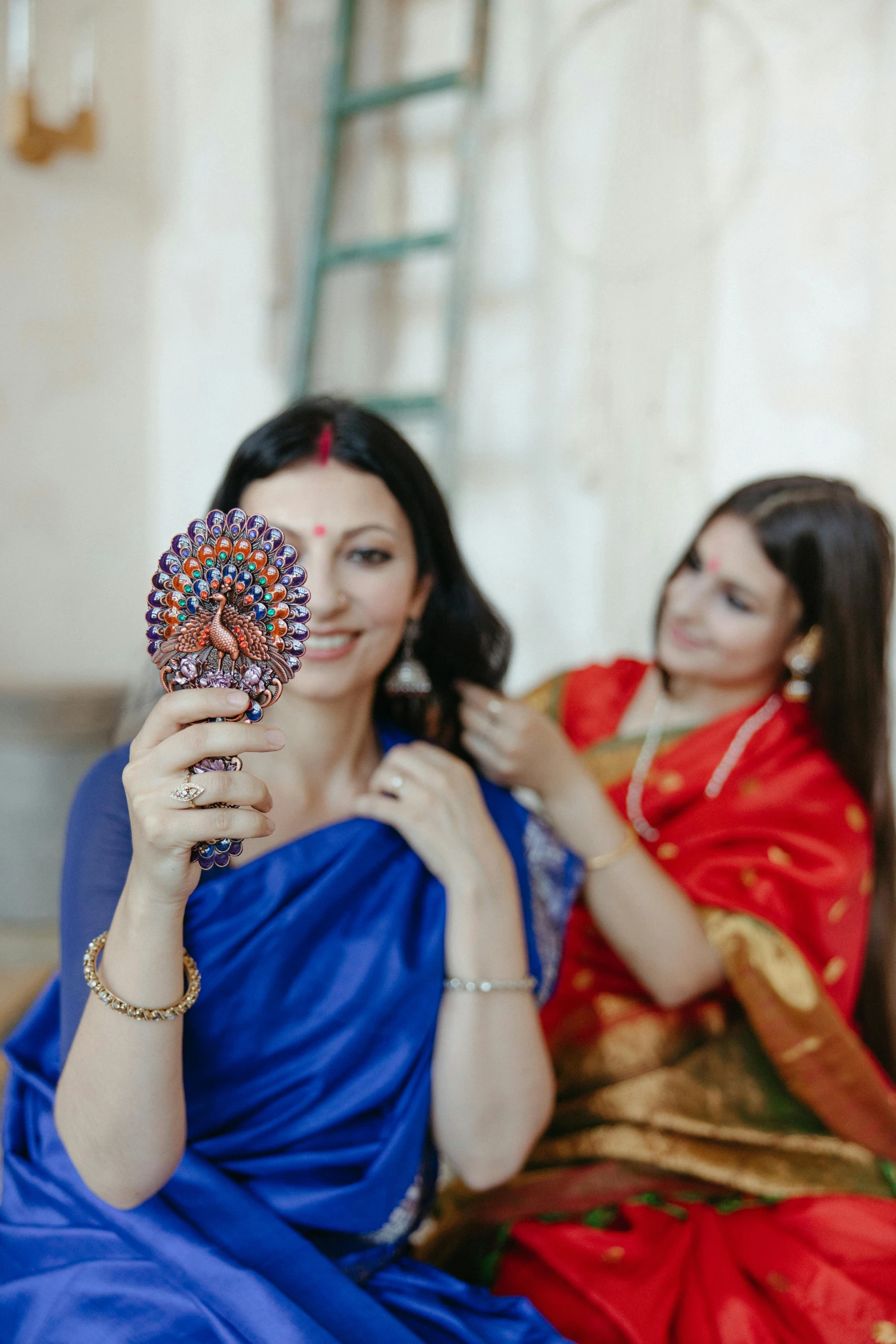 a couple of women sitting next to each other, pexels contest winner, bengal school of art, with a mirror, festive, profile image, promotional image