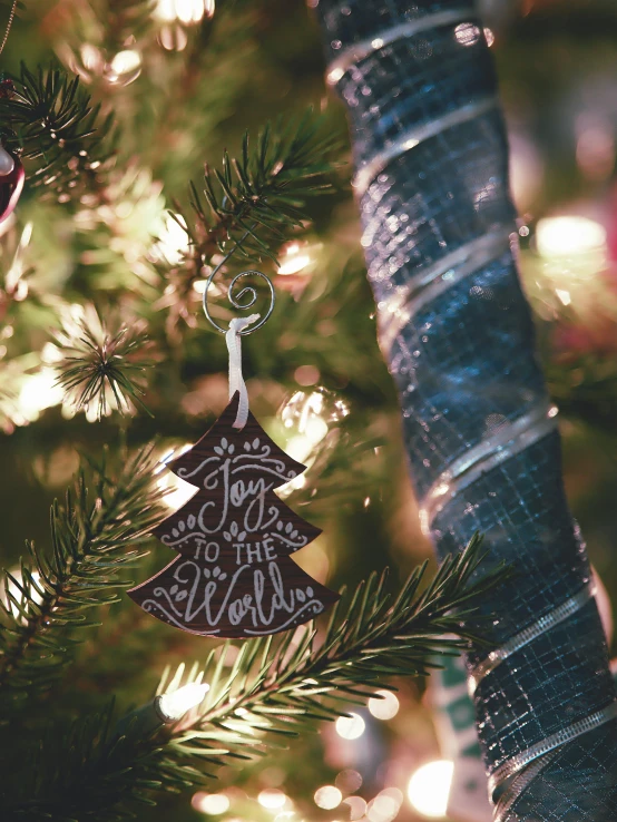 a close up of a christmas tree with ornaments on it, by Joy Garnett, pexels, folk art, saying, black fir, made of intricate metal and wood, high quality picture