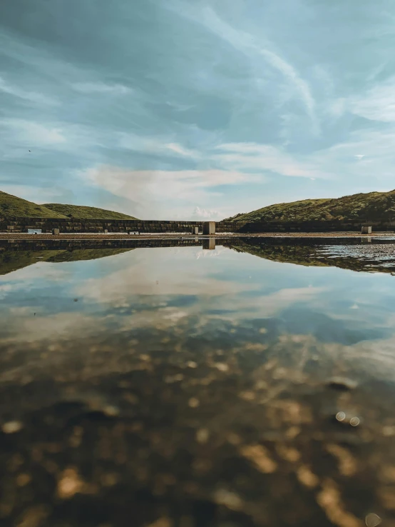 a body of water with a bridge in the background, a picture, pexels contest winner, mirrored, marsden, today\'s featured photograph 4k, cinematic view from lower angle