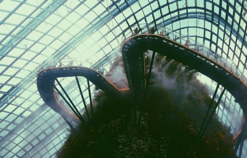 a very tall building with a lot of smoke coming out of it, inspired by Elsa Bleda, pexels contest winner, surrealism, water flows inside the terrarium, wide grand staircase, singapore, 🎀 🧟 🍓 🧚