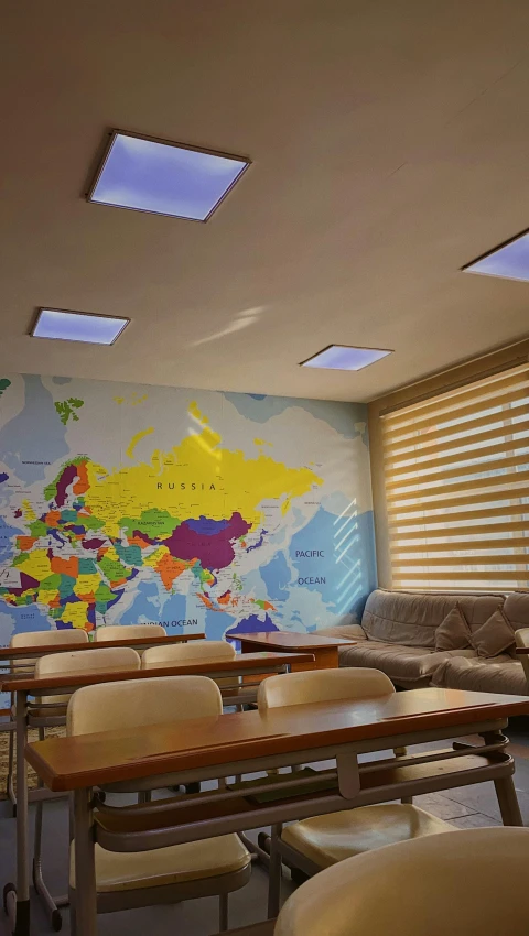 a classroom with a map of the world on the wall, a digital rendering, danube school, rgb wall light, aykut aydogdu, 64x64, skylight open ceiling