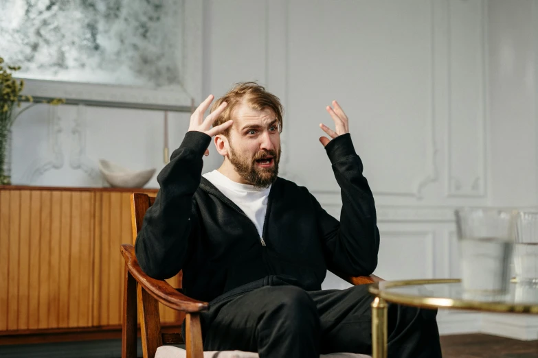 a man sitting in a chair talking on a cell phone, demna gvasalia, asmongold, high-quality photo, the actor