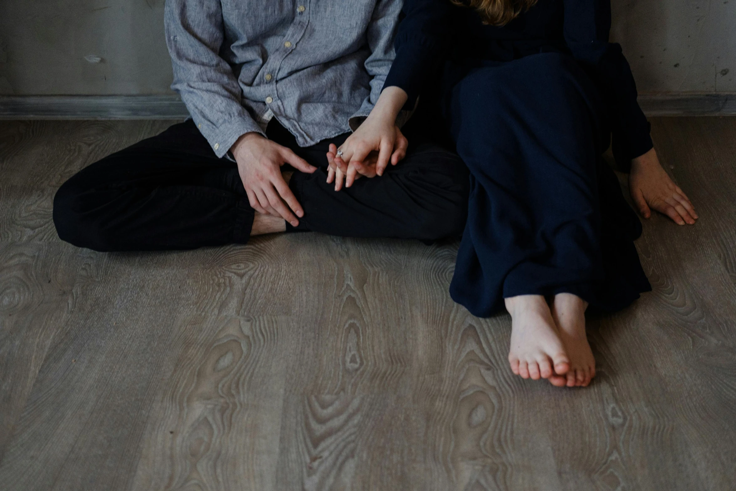 a man and a woman sitting on the floor, wooden floors, profile image, hands not visible, dasha taran