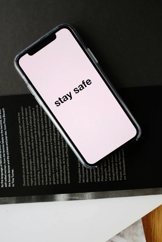 a cell phone sitting on top of a book, trending on pexels, worksafe. instagram photo, 2 5 6 x 2 5 6, pink skin, translucent sss xray