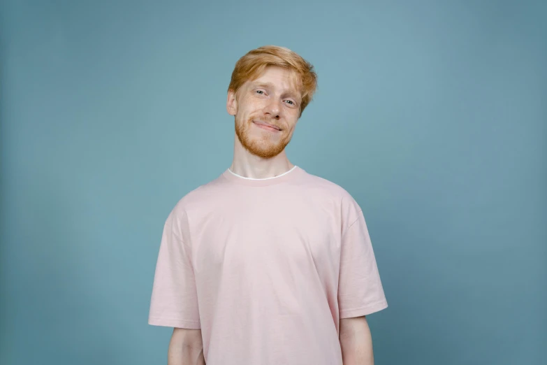 a man with a beard wearing a pink shirt, pexels contest winner, ginger hair, wearing a light blue shirt, linus from linustechtips, empty background