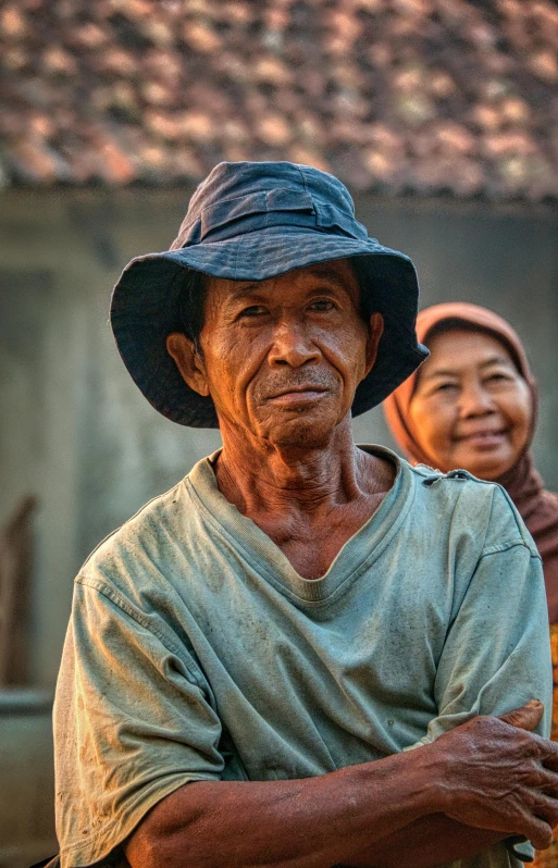 a couple of men standing next to each other, pexels contest winner, sumatraism, wearing farm clothes, older woman, south east asian with round face, late afternoon