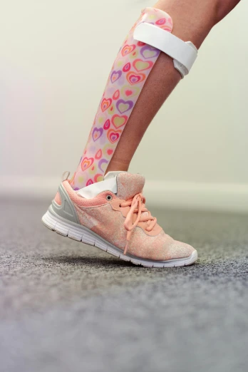 the legs of a woman in pink running shoes, by Daarken, standing in corner of room, foot wraps, paisley, hearts