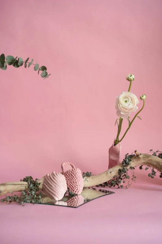 a vase filled with flowers sitting on top of a table, pink background, natural materials, love theme, bubbly