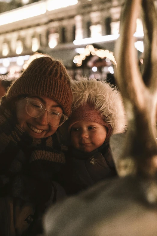 a couple of people standing next to each other, by Jaakko Mattila, pexels contest winner, festive, with a kid, warm features, square