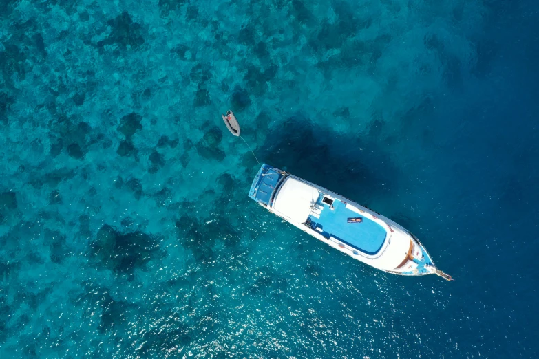 a couple of boats floating on top of a body of water, blue ocean, overhead, zenobia, flatlay